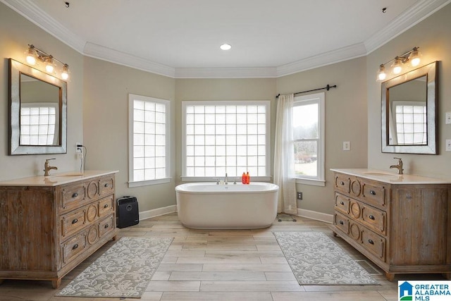 bathroom with hardwood / wood-style floors, a bathtub, a wealth of natural light, and ornamental molding