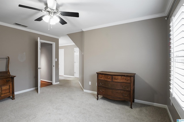 carpeted bedroom with ornamental molding and ceiling fan