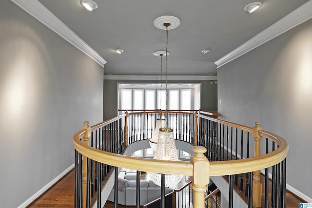 stairway with crown molding and wood-type flooring