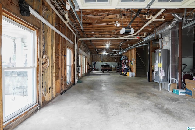 garage featuring a garage door opener and water heater