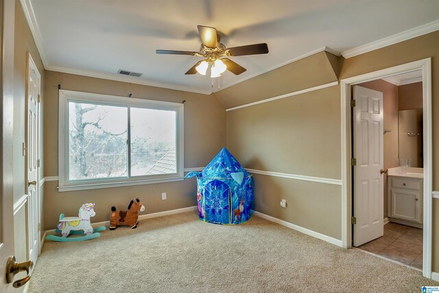 game room with ornamental molding, light colored carpet, and ceiling fan