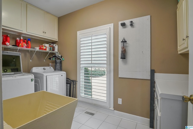 washroom with cabinets, light tile patterned floors, and independent washer and dryer