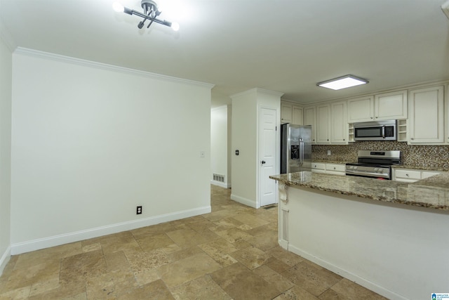 kitchen featuring crown molding, appliances with stainless steel finishes, light stone countertops, and backsplash