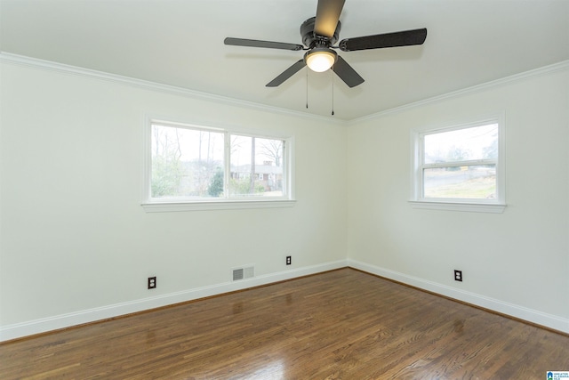 spare room featuring crown molding and dark hardwood / wood-style flooring