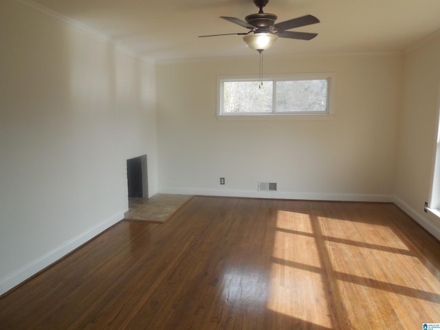 spare room featuring hardwood / wood-style floors, crown molding, and ceiling fan