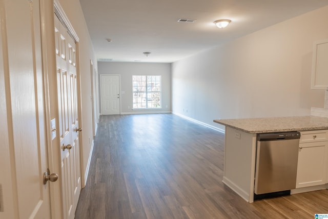 interior space featuring white cabinetry, dark hardwood / wood-style flooring, dishwasher, and light stone countertops