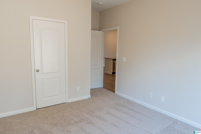 unfurnished bedroom with light colored carpet