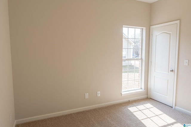 spare room with light colored carpet