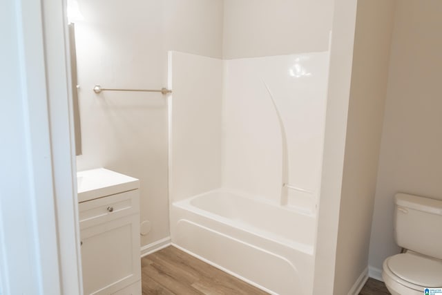 full bathroom featuring vanity, hardwood / wood-style floors, shower / tub combination, and toilet