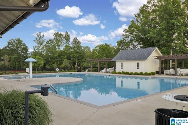 pool featuring a patio, fence, and a pergola