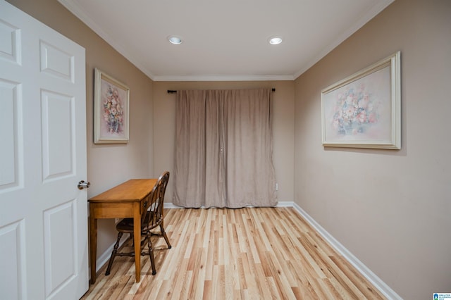 office with crown molding and light hardwood / wood-style flooring