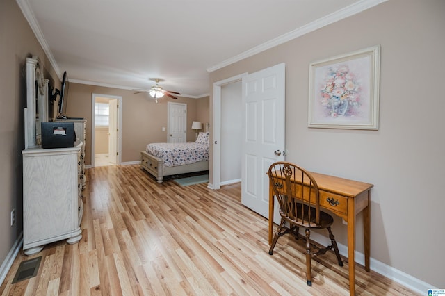 bedroom featuring ornamental molding, ensuite bathroom, and light wood-type flooring