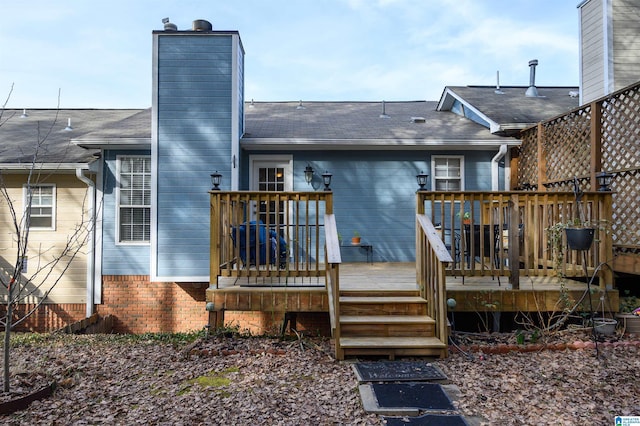 rear view of house with a wooden deck