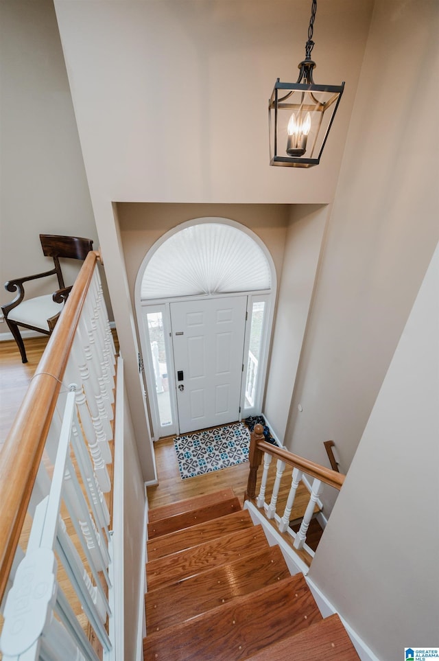 foyer entrance featuring hardwood / wood-style flooring and a notable chandelier