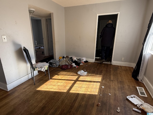 bedroom with dark hardwood / wood-style floors