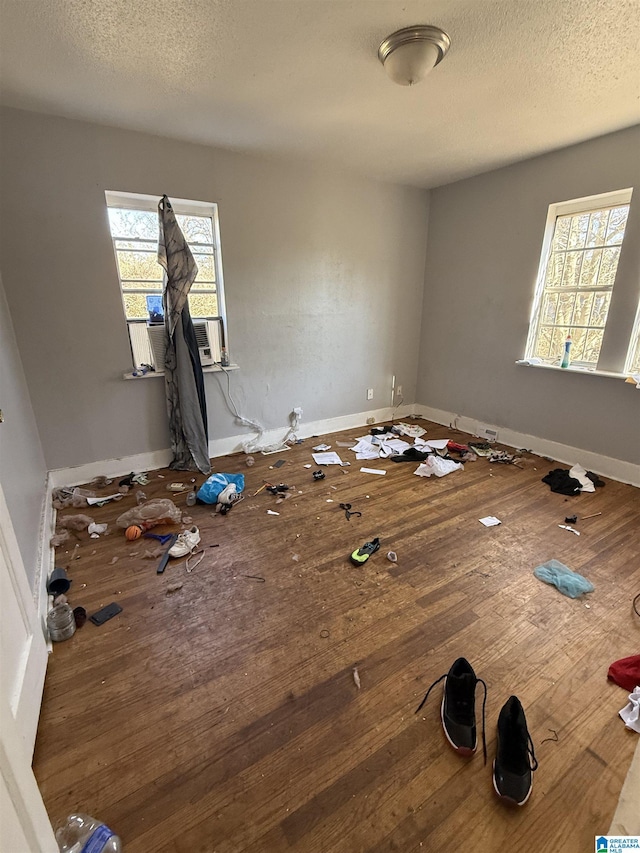 unfurnished bedroom featuring hardwood / wood-style flooring and a textured ceiling