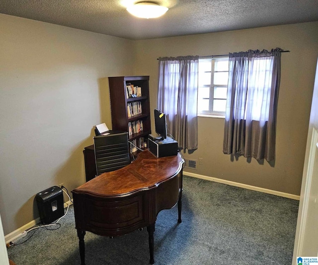 carpeted home office with a textured ceiling