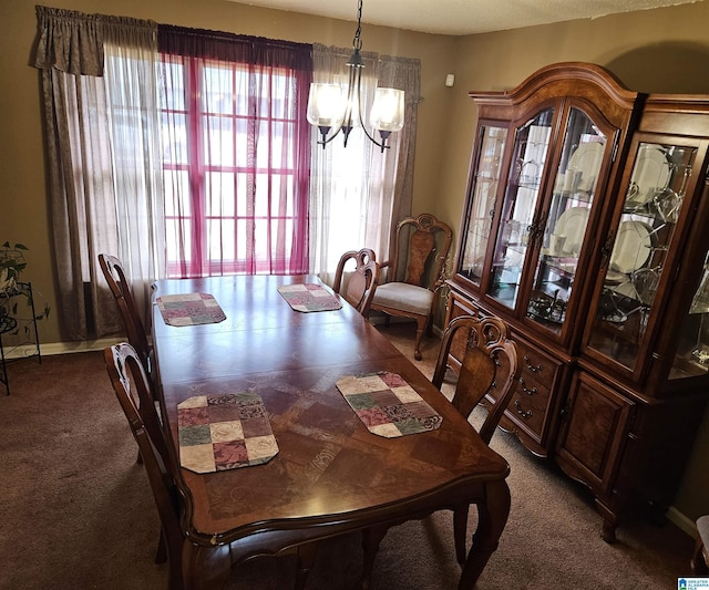 dining space featuring dark colored carpet and a notable chandelier