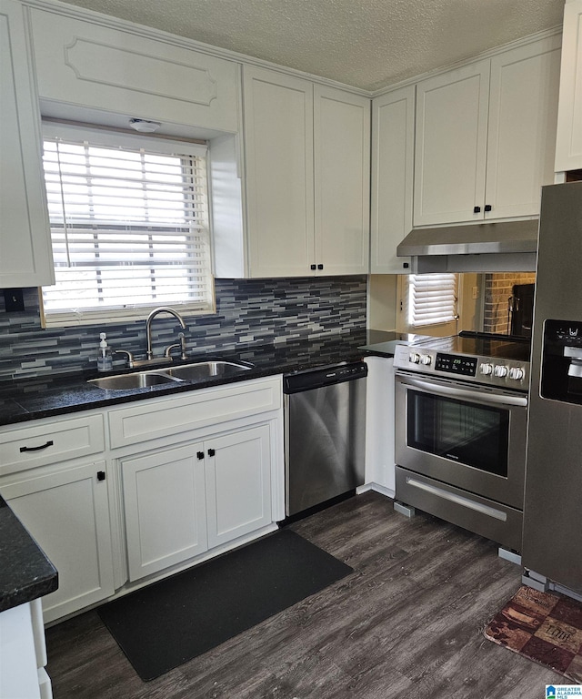 kitchen featuring stainless steel appliances, dark hardwood / wood-style flooring, sink, and white cabinets