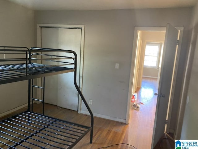 bedroom featuring hardwood / wood-style floors and a closet