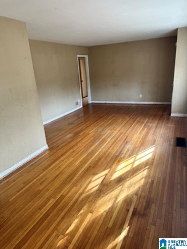 unfurnished room with wood-type flooring