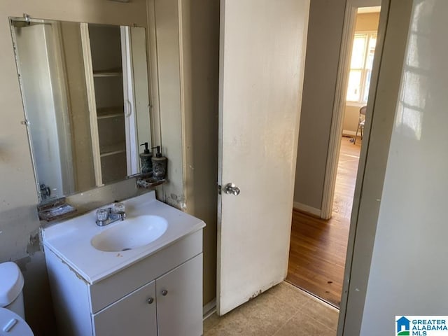 bathroom with vanity, tile patterned floors, and toilet