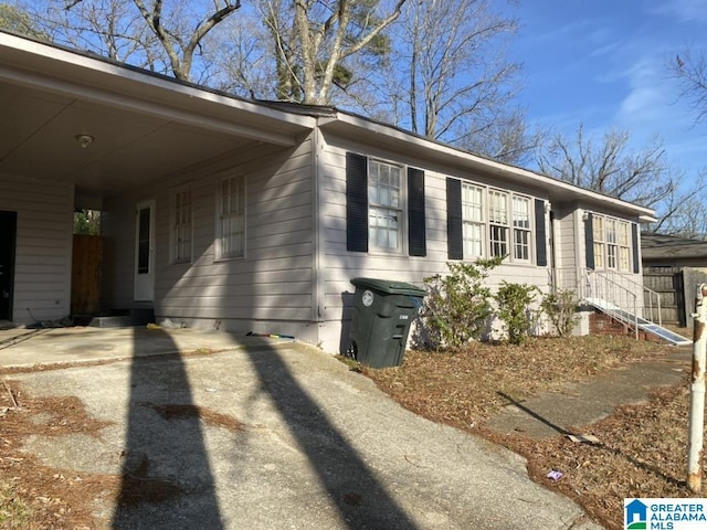 view of home's exterior featuring a carport