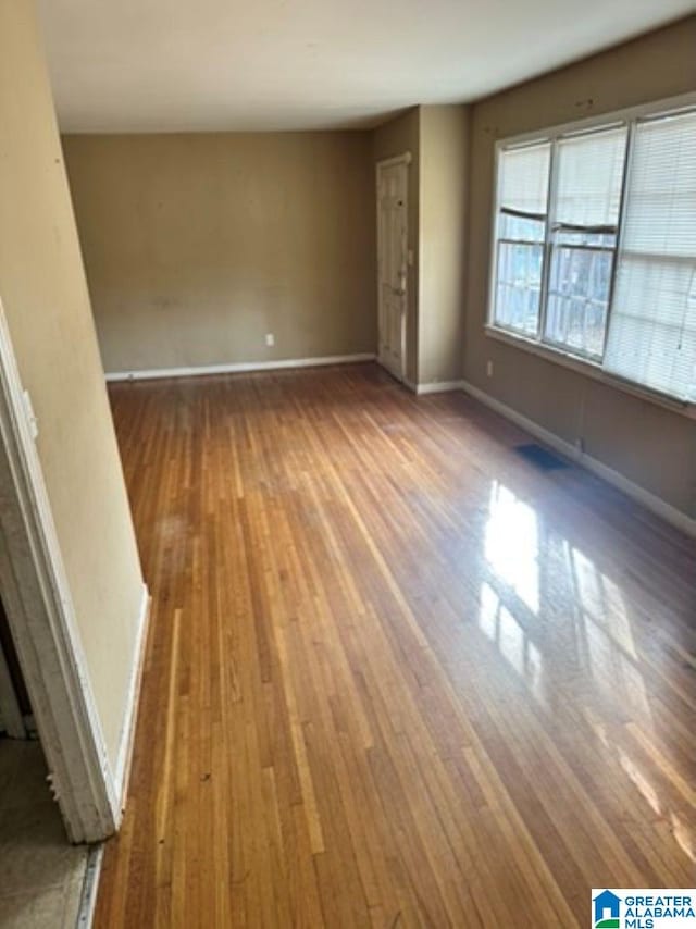 spare room with hardwood / wood-style floors