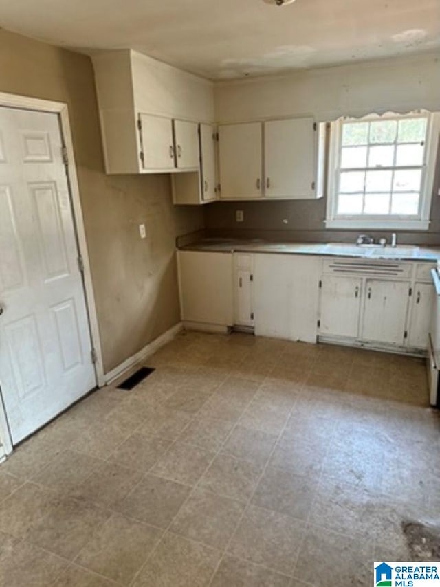 kitchen with white cabinetry and sink