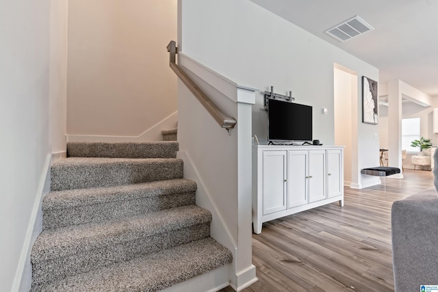 staircase featuring wood-type flooring