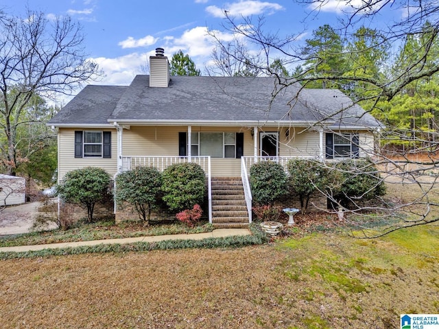 view of front of home featuring covered porch and a front yard