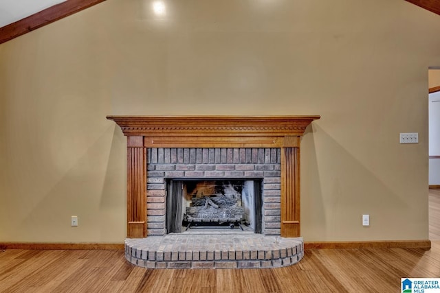 room details featuring a brick fireplace and hardwood / wood-style floors