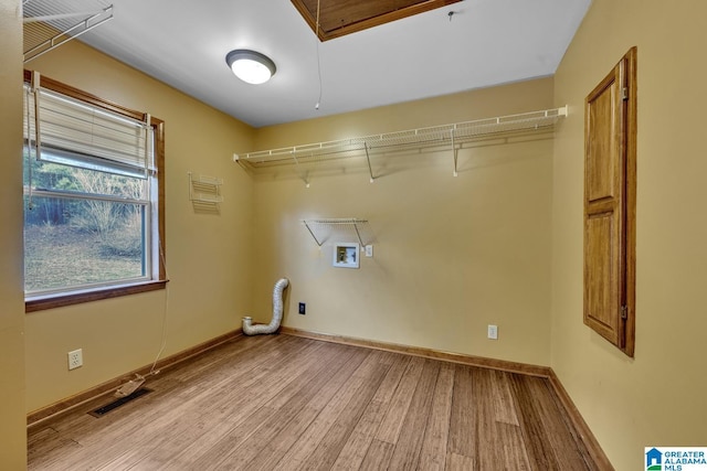 washroom featuring hookup for a washing machine and light wood-type flooring