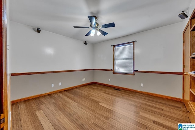 empty room featuring ceiling fan and light hardwood / wood-style floors