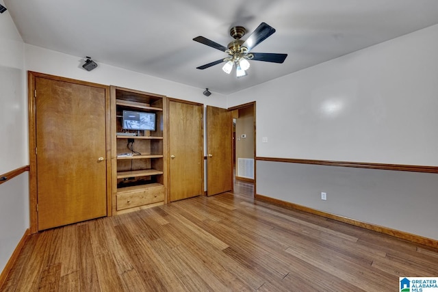 unfurnished bedroom with ceiling fan and light hardwood / wood-style flooring