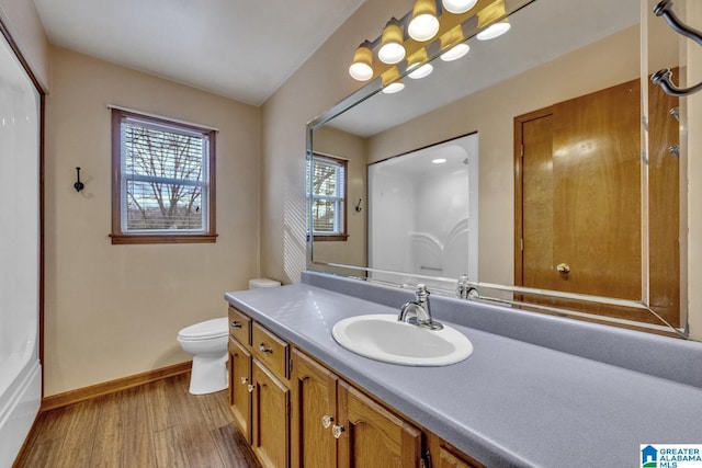 bathroom with hardwood / wood-style flooring, vanity, and toilet