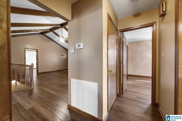 corridor with dark wood-type flooring and lofted ceiling with beams