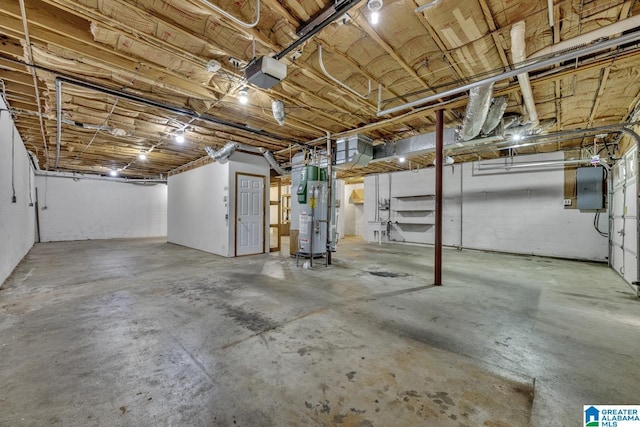 basement featuring electric panel and water heater