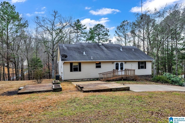 back of house featuring a wooden deck, a yard, and central AC unit