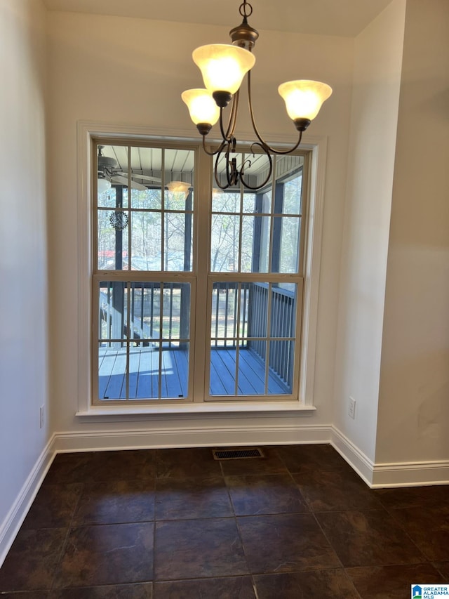 unfurnished dining area featuring an inviting chandelier