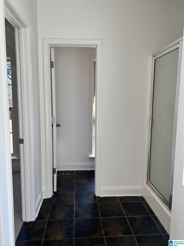 bathroom with tile patterned flooring and an enclosed shower