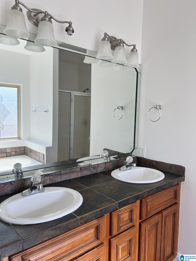 bathroom featuring shower with separate bathtub and vanity