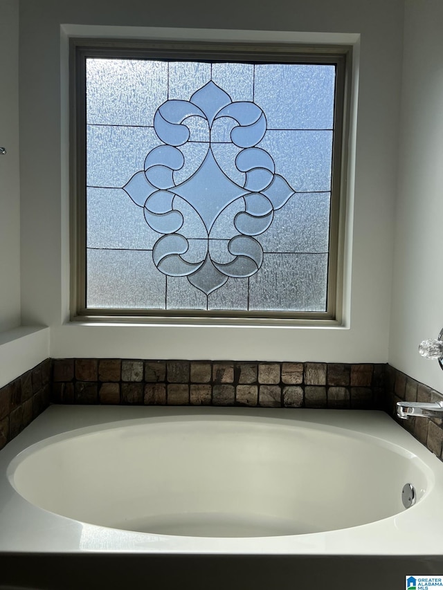 bathroom with a tub to relax in