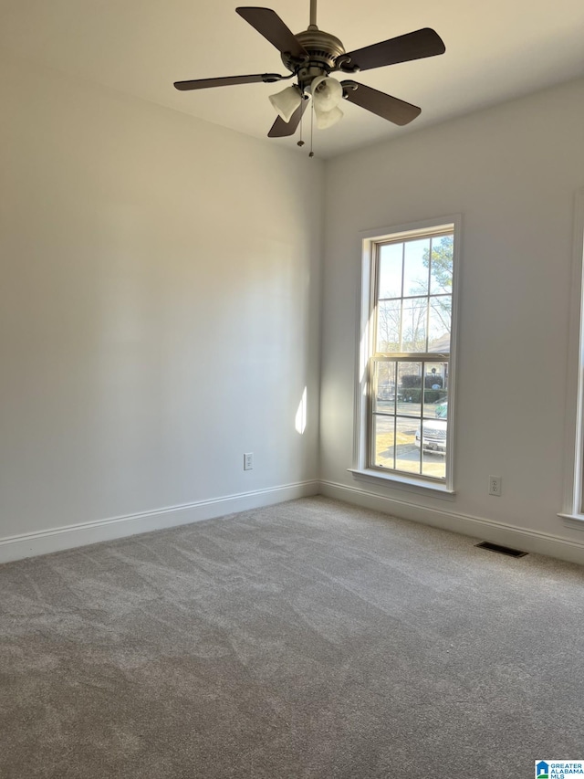 carpeted empty room featuring ceiling fan