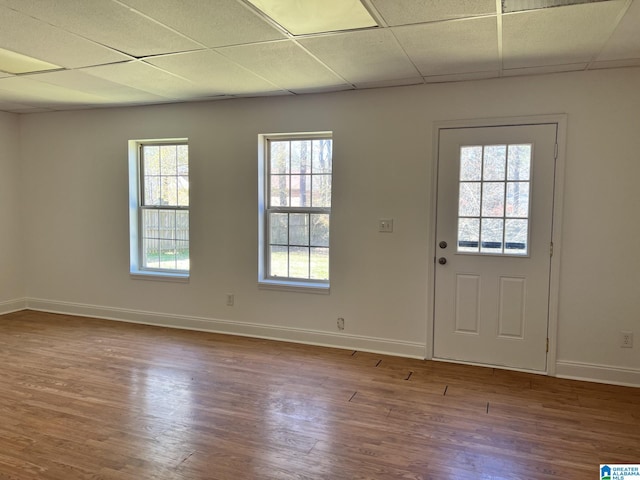 interior space with hardwood / wood-style flooring and a paneled ceiling