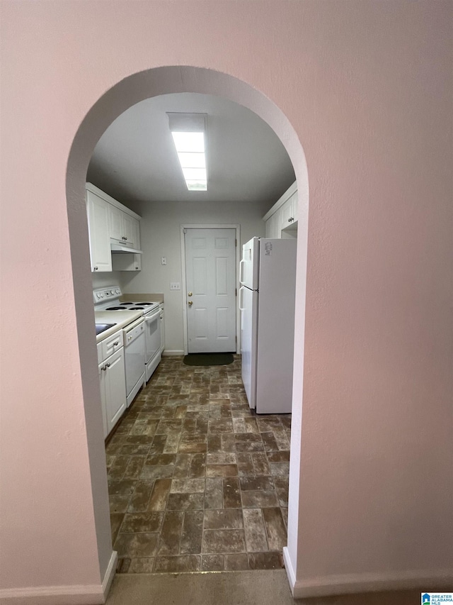 kitchen featuring white appliances and white cabinets