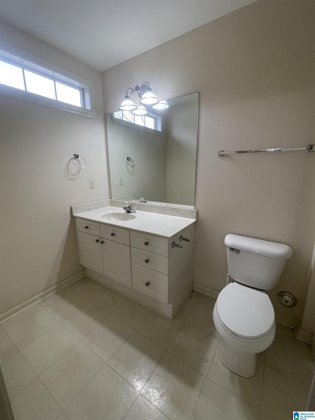 bathroom with vanity, tile patterned floors, and toilet