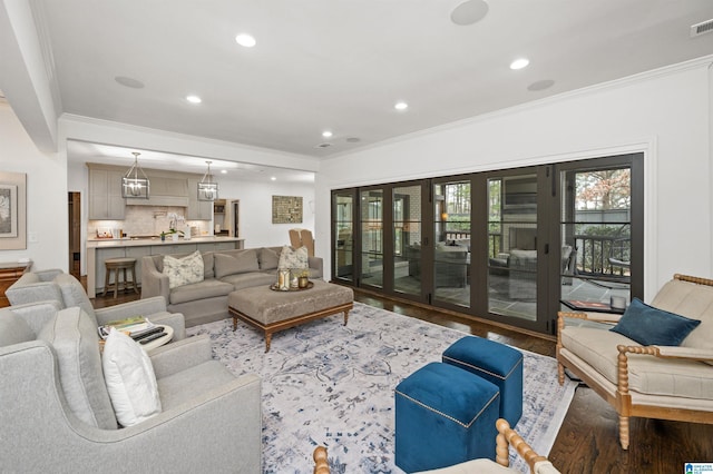 living room featuring crown molding, hardwood / wood-style floors, and french doors