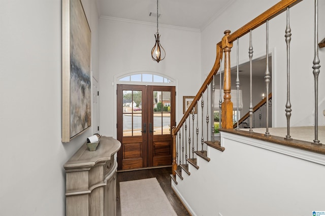 entrance foyer featuring crown molding, dark hardwood / wood-style floors, and french doors