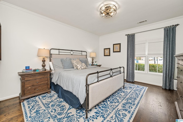 bedroom featuring crown molding and dark wood-type flooring